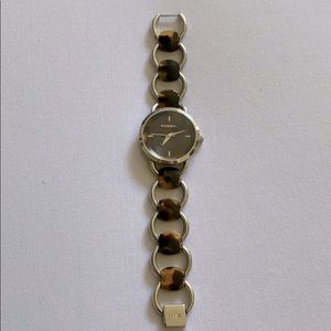 Fossil tortoise with silver chain link watch